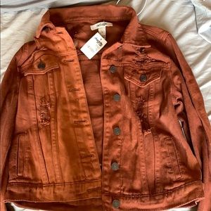 Rust colored ripped jean jacket